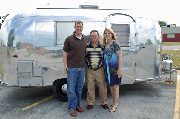 Behind us is one of Mr. Huttle's own personal Airstreams -- a 16-foot 1962 Bambi II. It's currently parked in front of company headquarters alongside some other historic units.